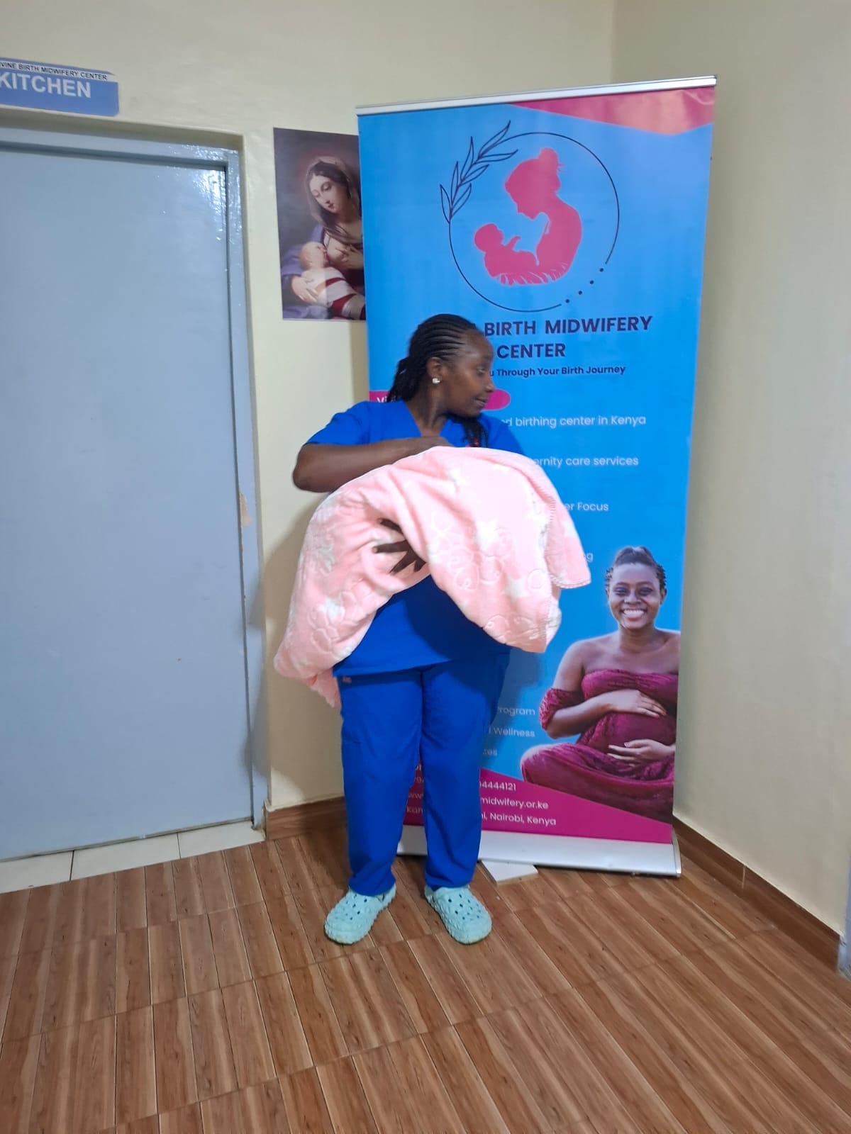 A new mother and her midwife together with her newborn after birth